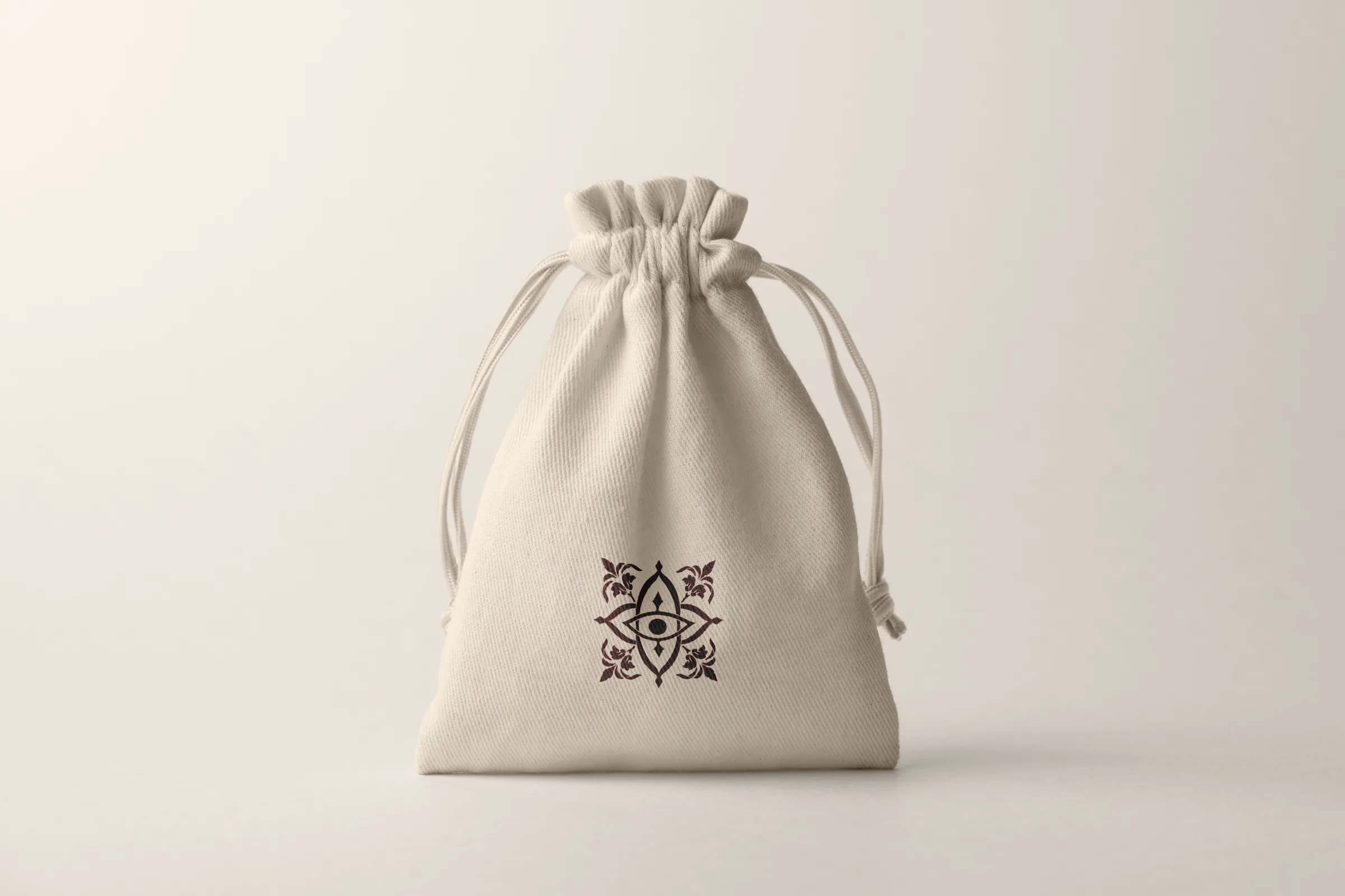 Cream cotton dust bag printed with the BĀGH emblem